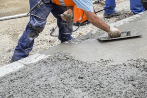 A construction worker practices concrete resurfacing