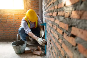 A mason restoring a brick wall.