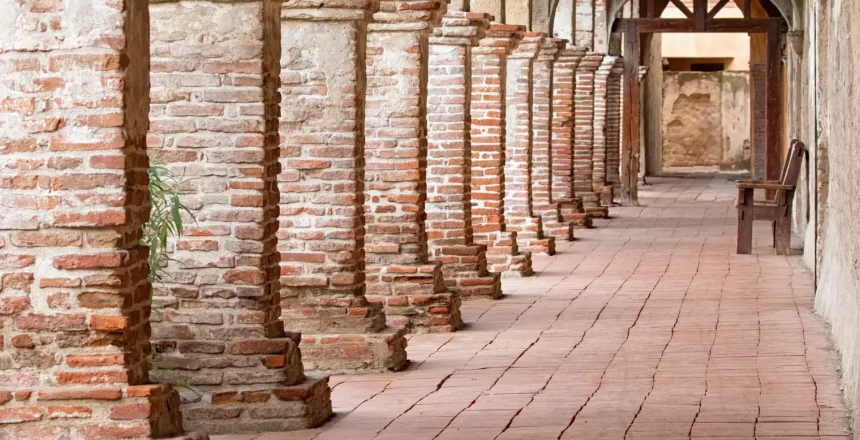A brick walkway flanked by multiple brick pillars.