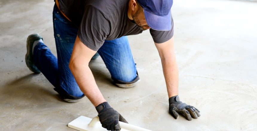 A concrete restoration contractor masoning the floor for the perfect surface grade.