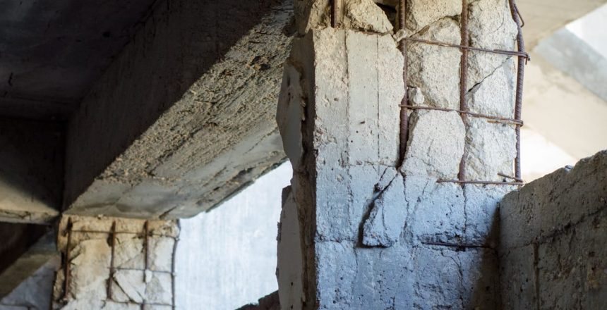 professional concrete restoration is often the only way to restore dilapidated foundations. Weathered concrete supports showing metal beams underneath.