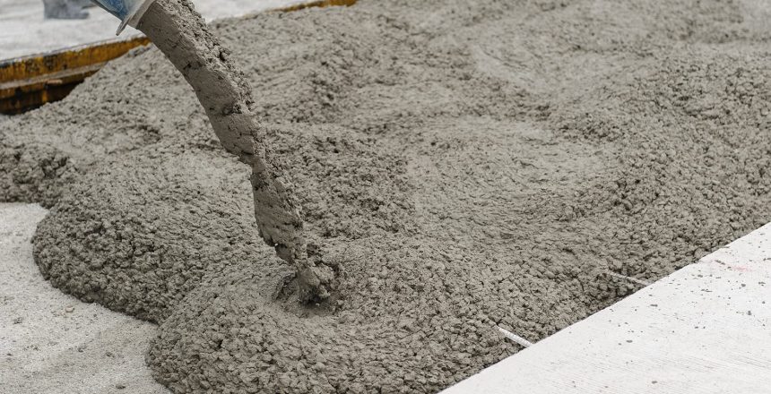 What is concrete made of and what makes it the go-to building material? A mixture of coarse liquid and cement. Concrete pouring in a construction site.